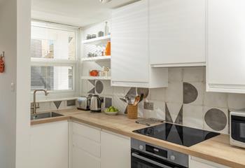 The kitchen is modern and stylish for preparing meals.