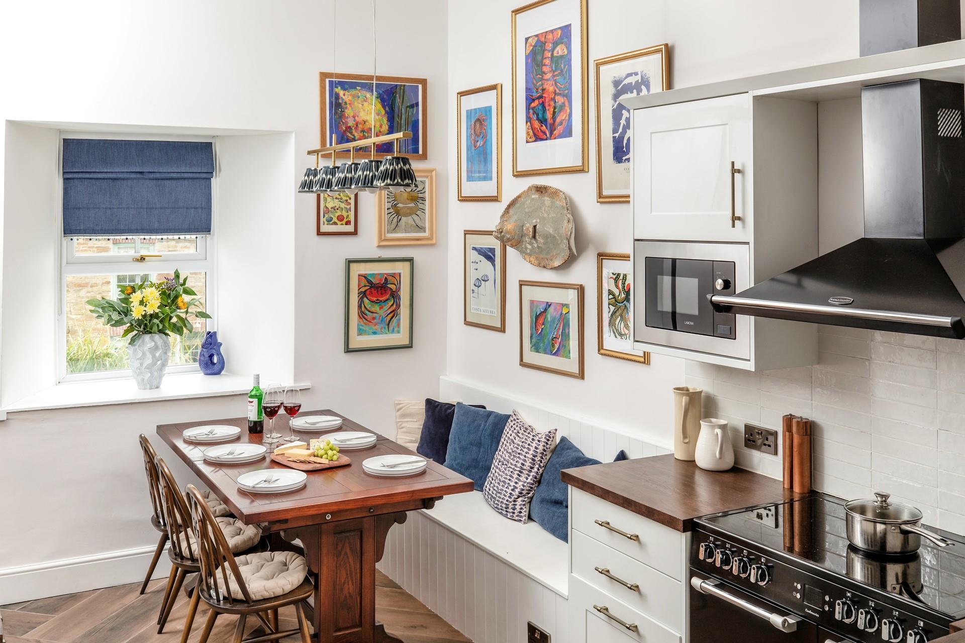 There is colourful and unique artwork in the kitchen.