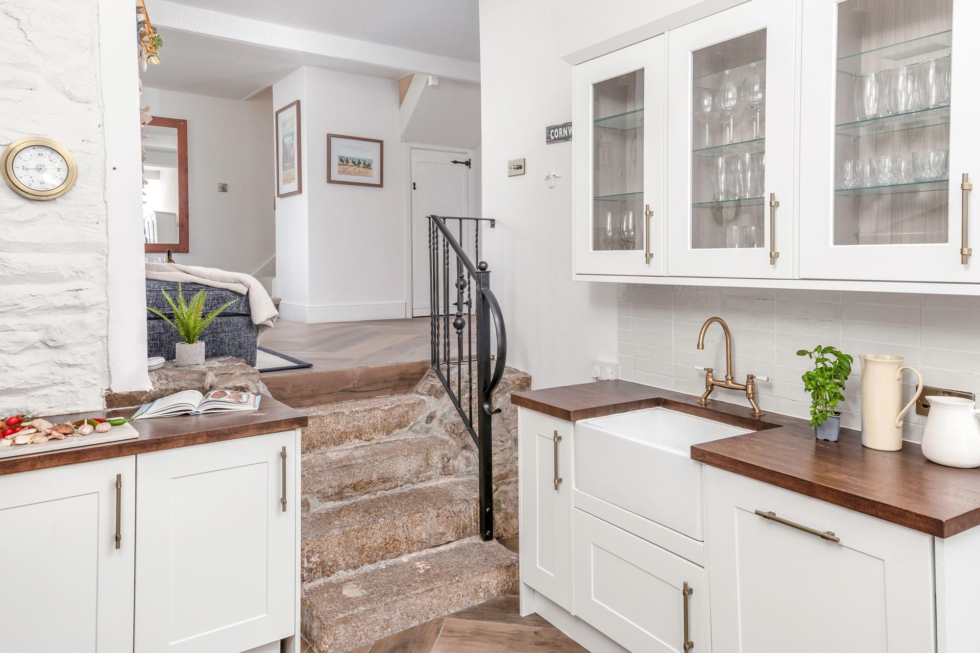 The kitchen has plenty of space for the chef of a family to cook a tasty meal.