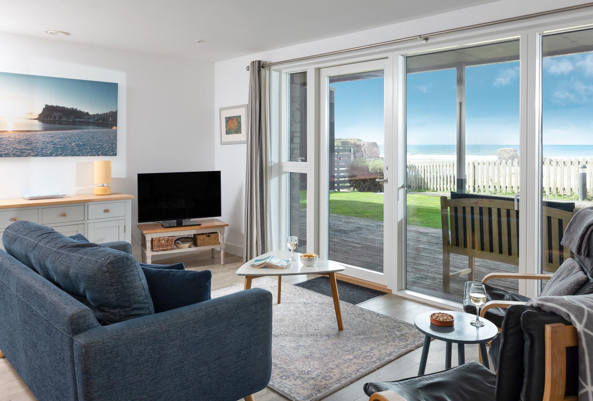 Bi-fold doors open and let the view and sea air in.