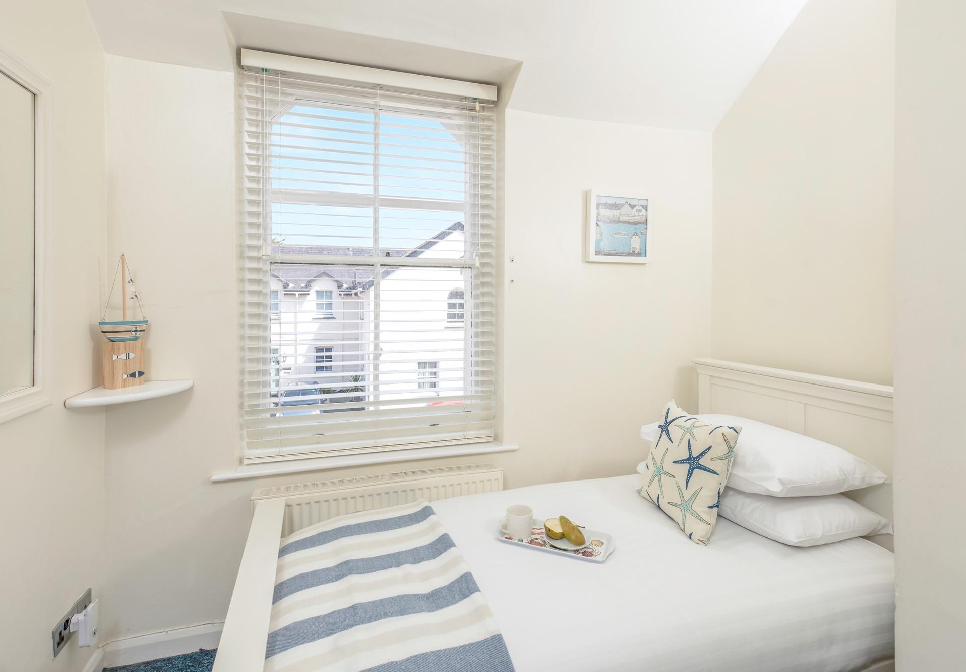 The single room is decorated with a calming blue ocean theme.