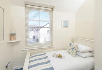 The single room is decorated with a calming blue ocean theme.