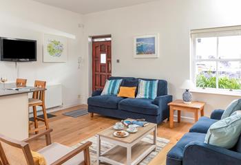 The living area is decorated with seaside colours.