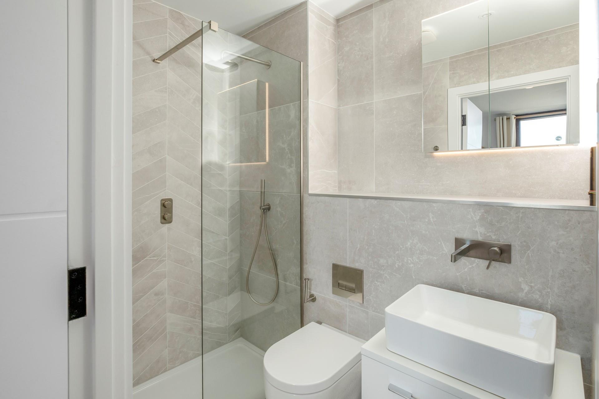 The stylish en suite shower room is ideal for washing sandy toes after beach days.