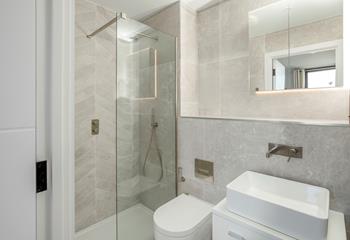 The stylish en suite shower room is ideal for washing sandy toes after beach days.