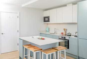 The kitchen is modern and sleek, perfect for cooking up a storm!