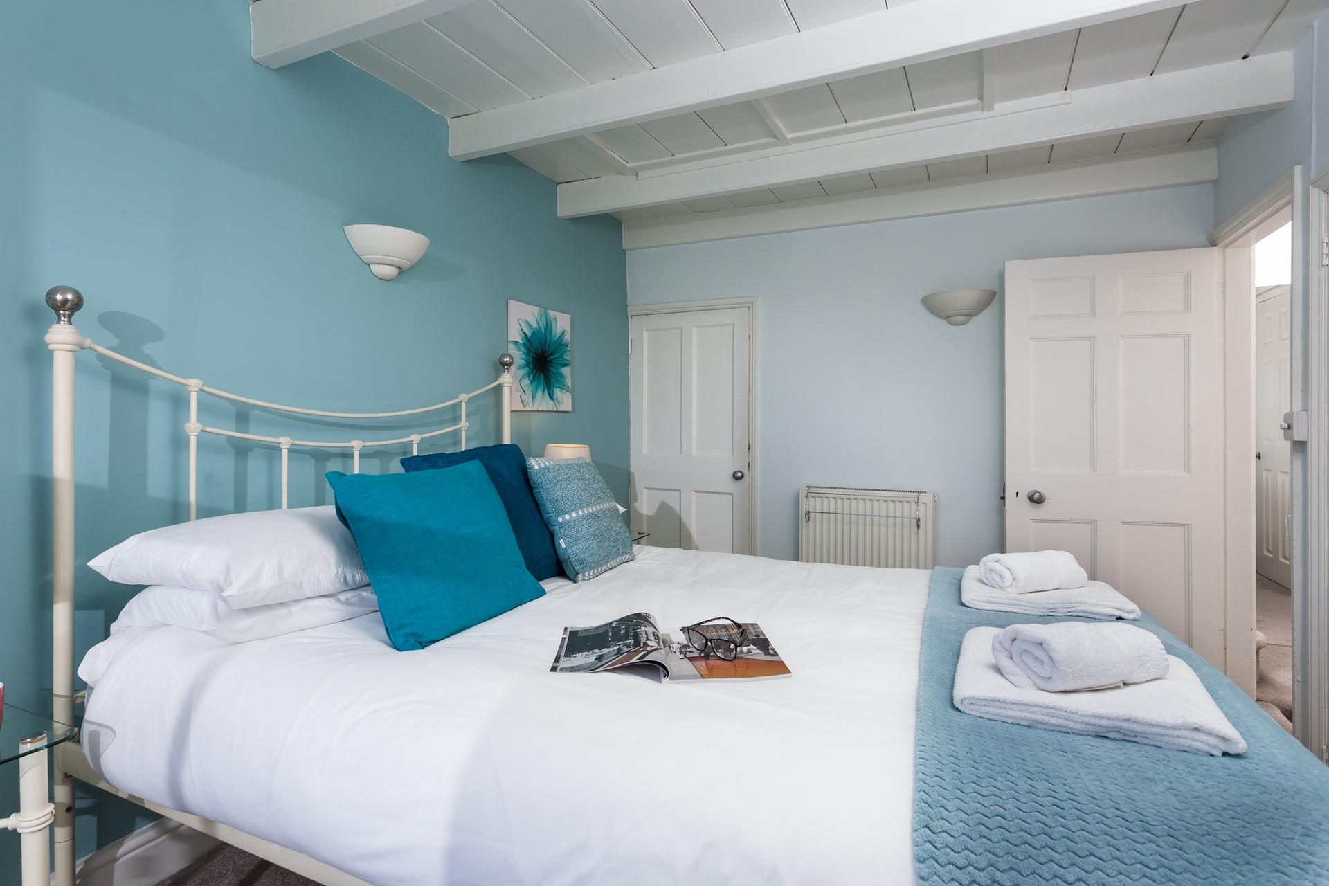 Coastal colours fill the main bedroom.