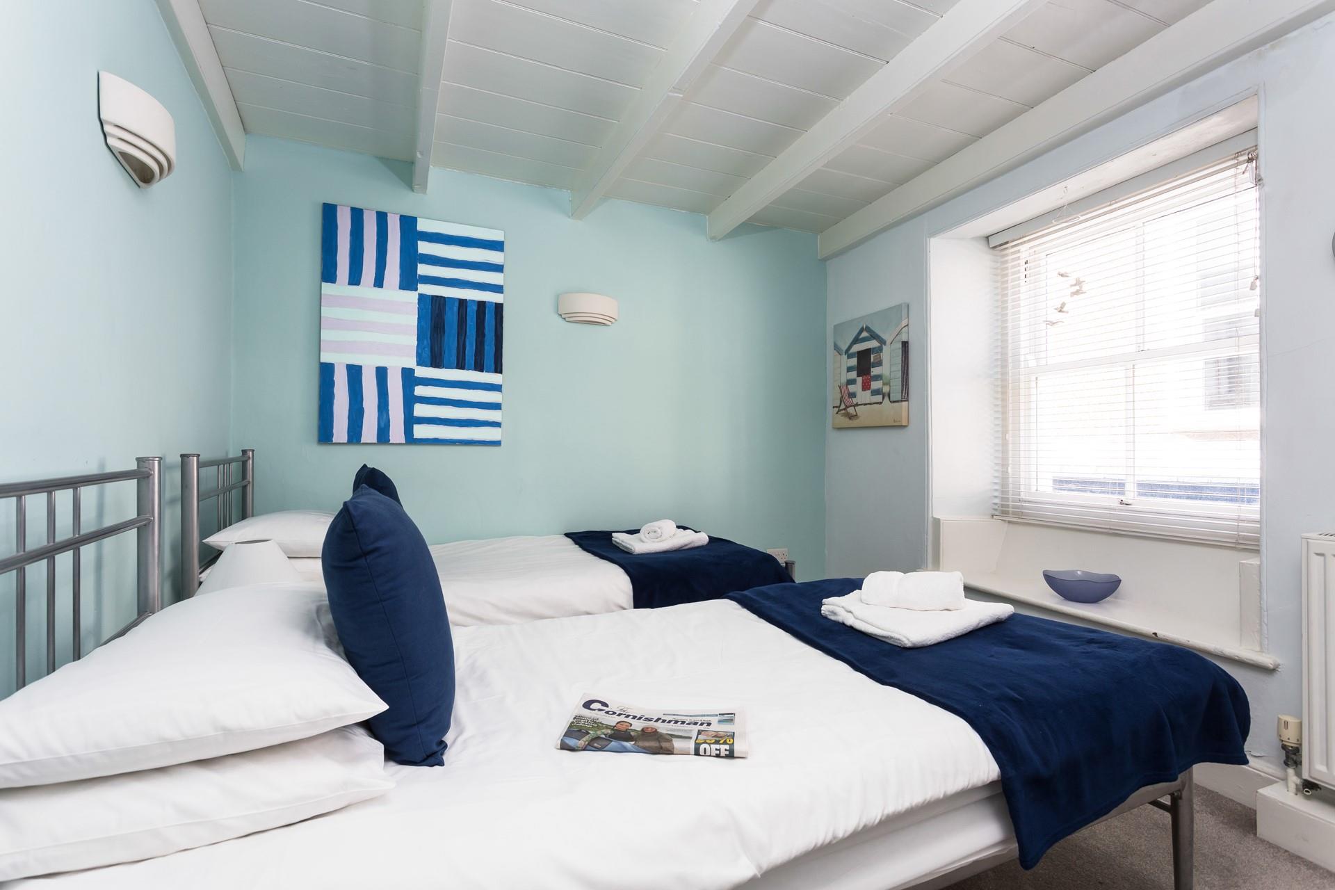 Bedroom two has twin beds for additional guests.