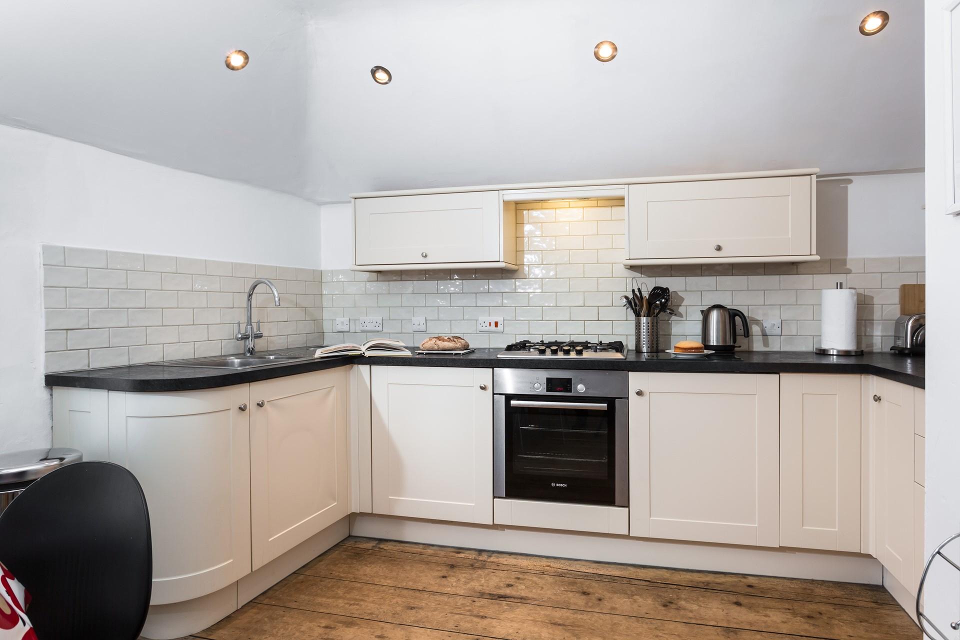 The kitchen is well equipped for preparing and cooking meals.