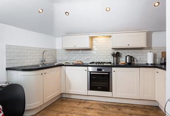 The kitchen is well equipped for preparing and cooking meals.