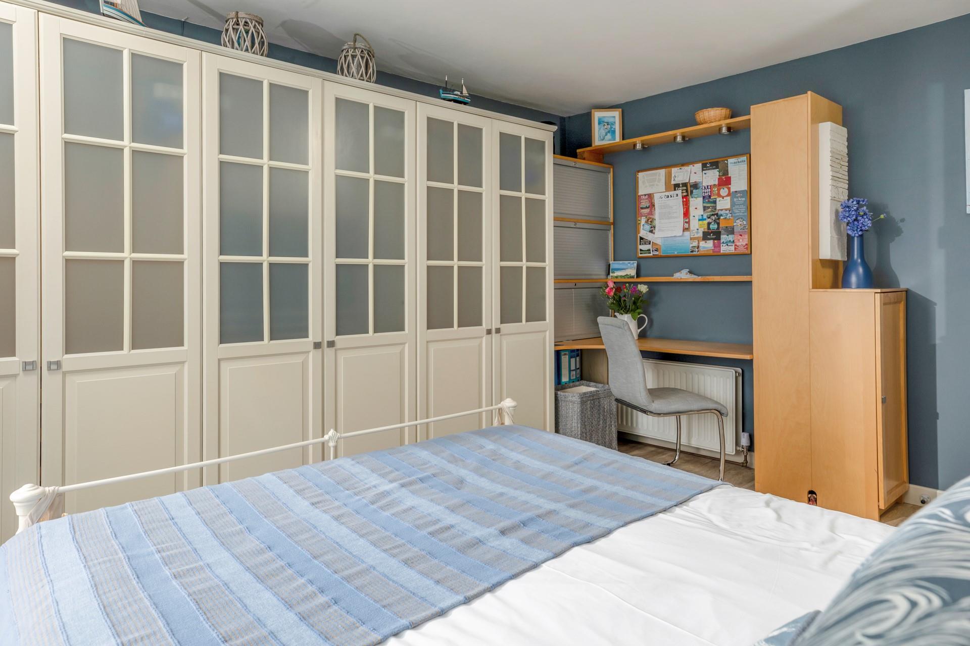 The bedroom is decorated with coastal blues.