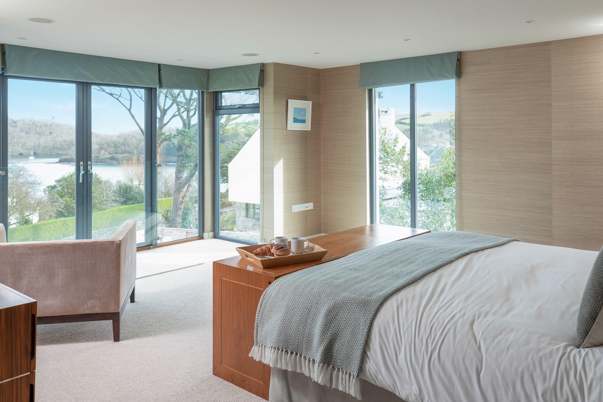 Open the blinds and enjoy the sunrise over the water.