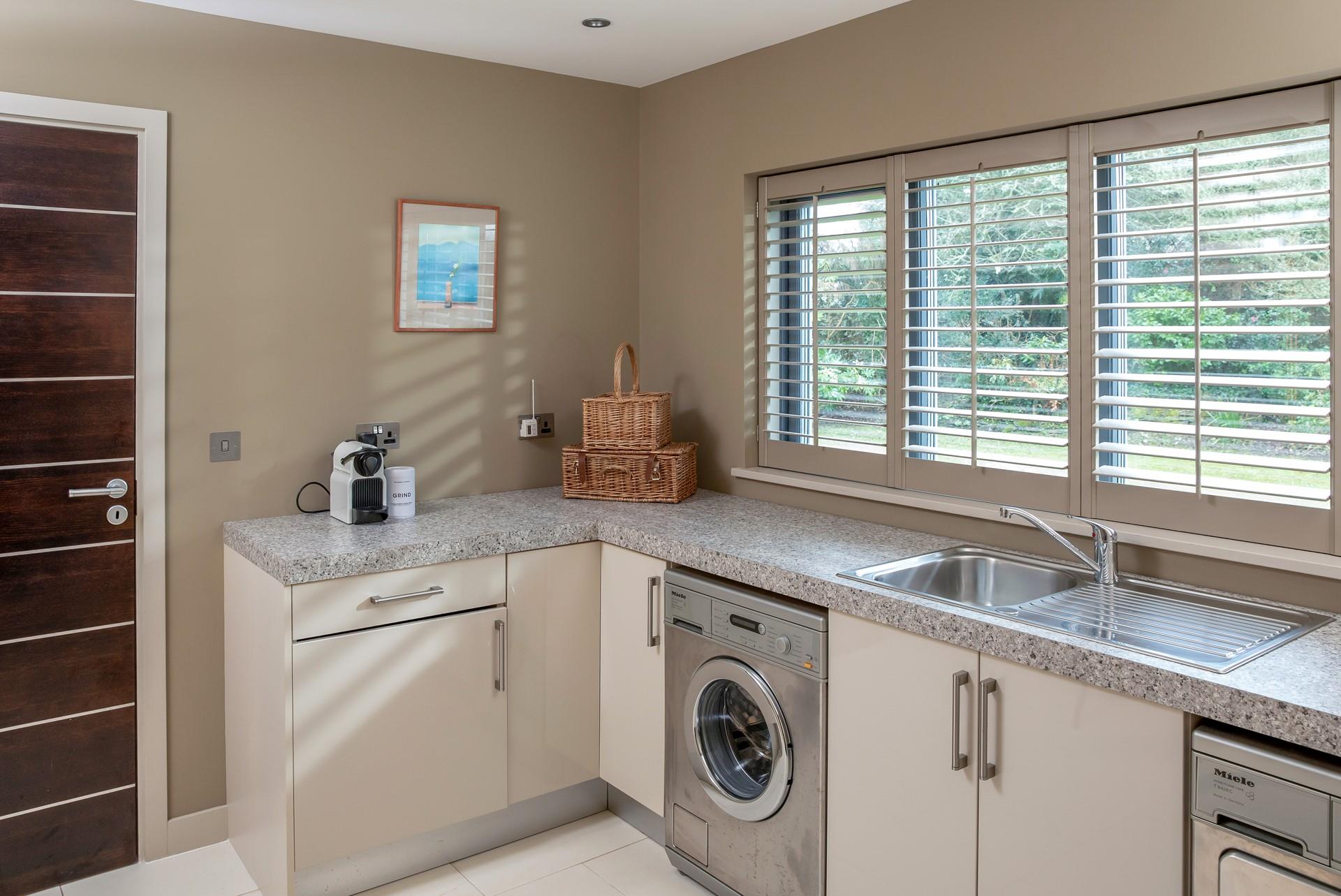 The utility area has a washer and dryer.