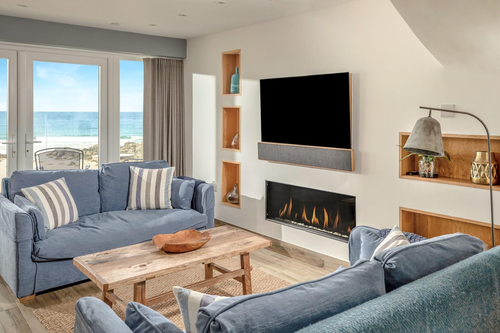 Sit in the stylish sitting room enjoying the waves in front of the fire.