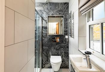 The en suite shower room is a modern space for getting ready daily.