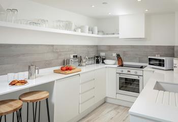 The kitchen is modern and well-equipped for cooking meals.