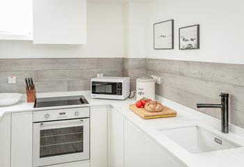 Modern and sleek, the kitchen is ideal for rustling up meals.