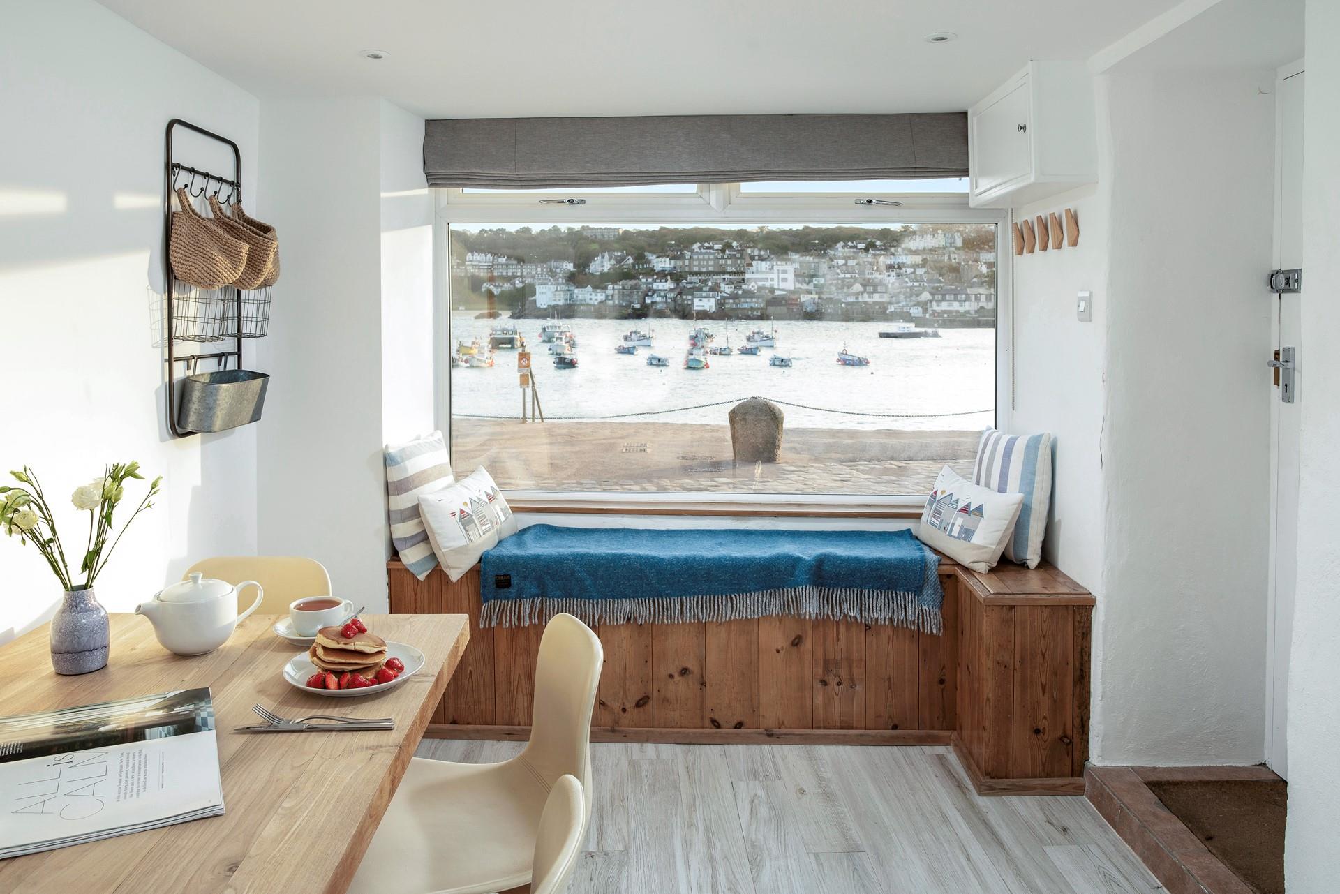 Gaze across the harbour watching the boats bob by.