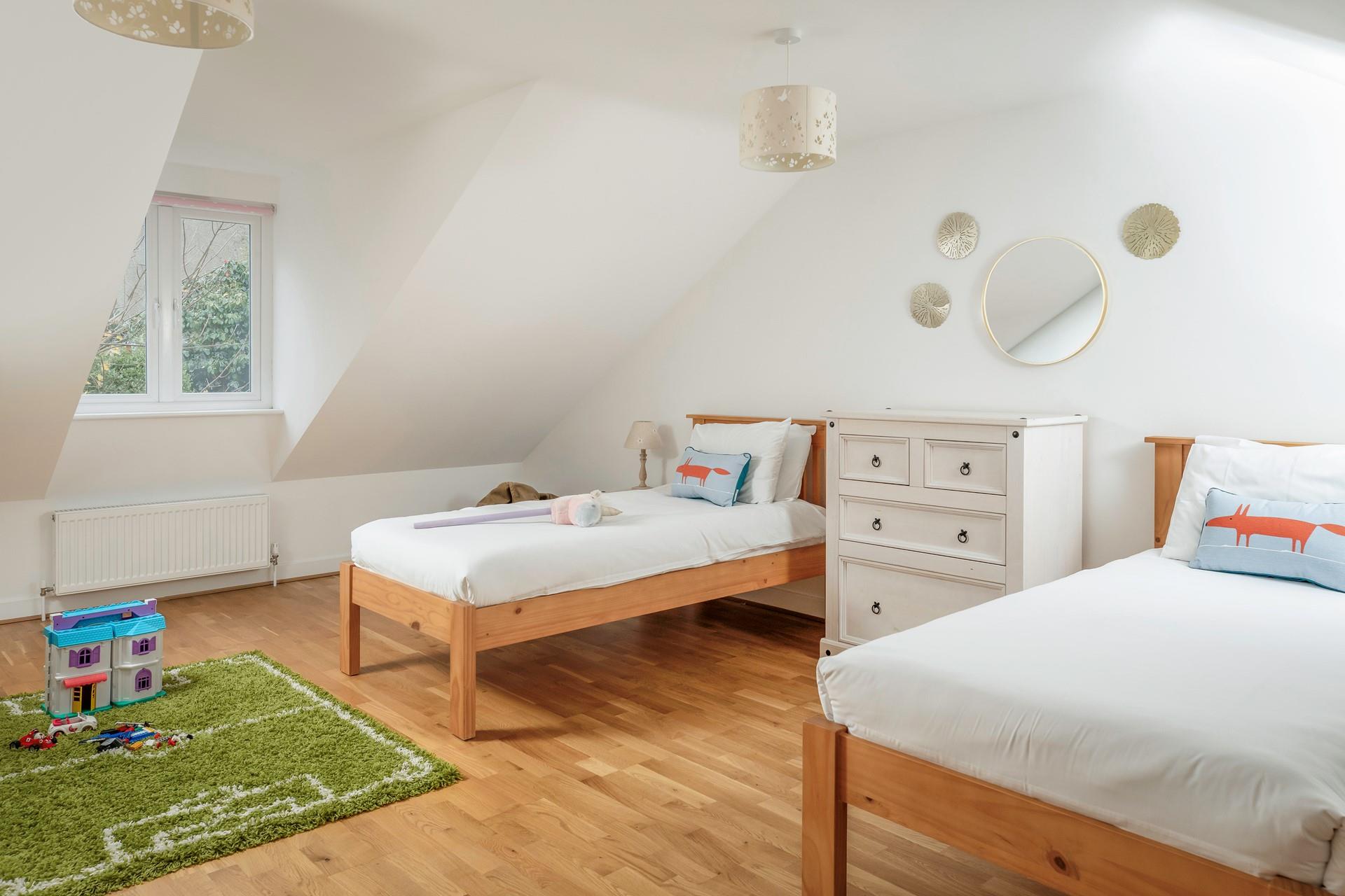 This spacious bedroom has twin beds.