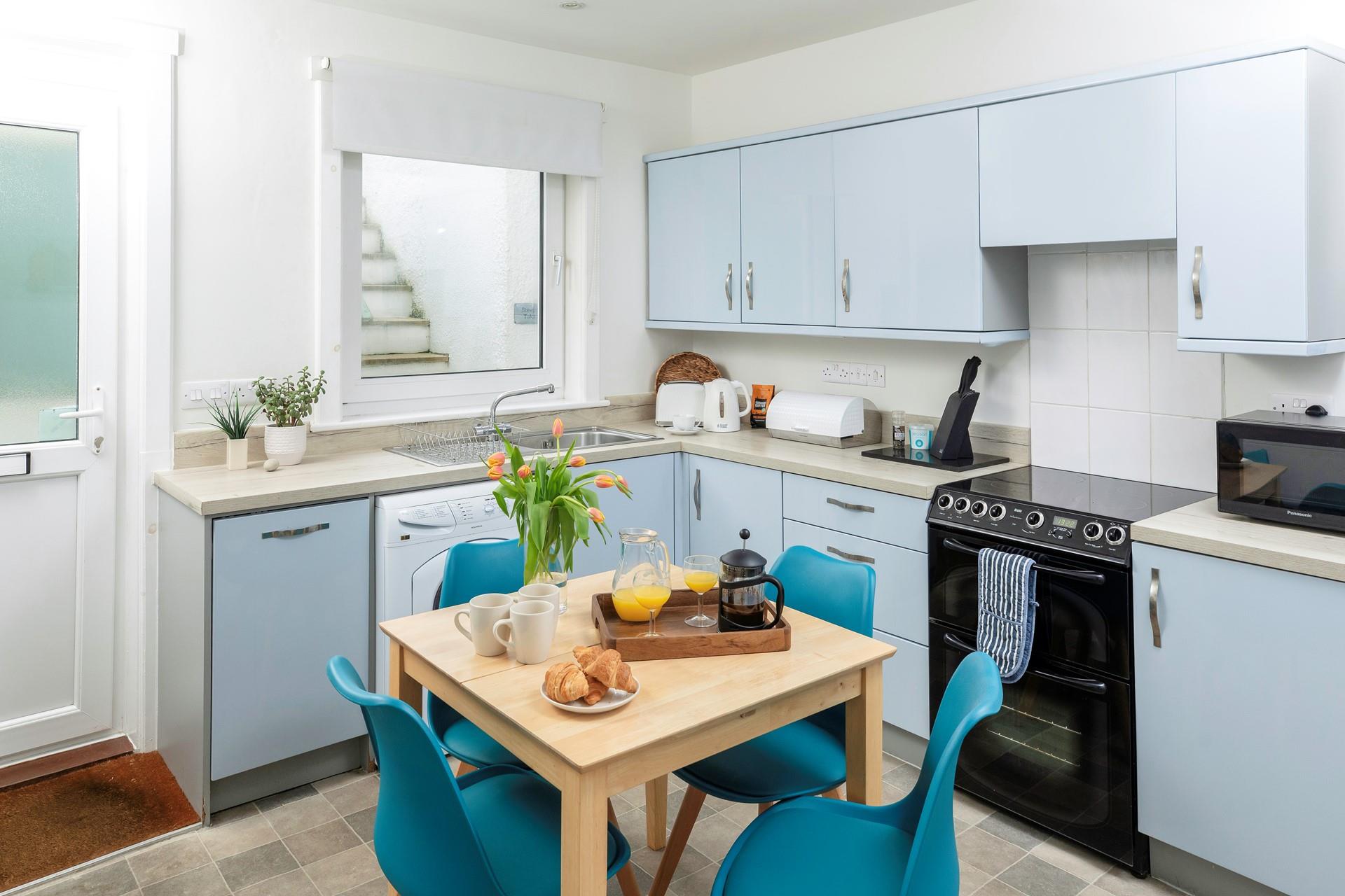 The kitchen is light and bright with all the amenities you need.