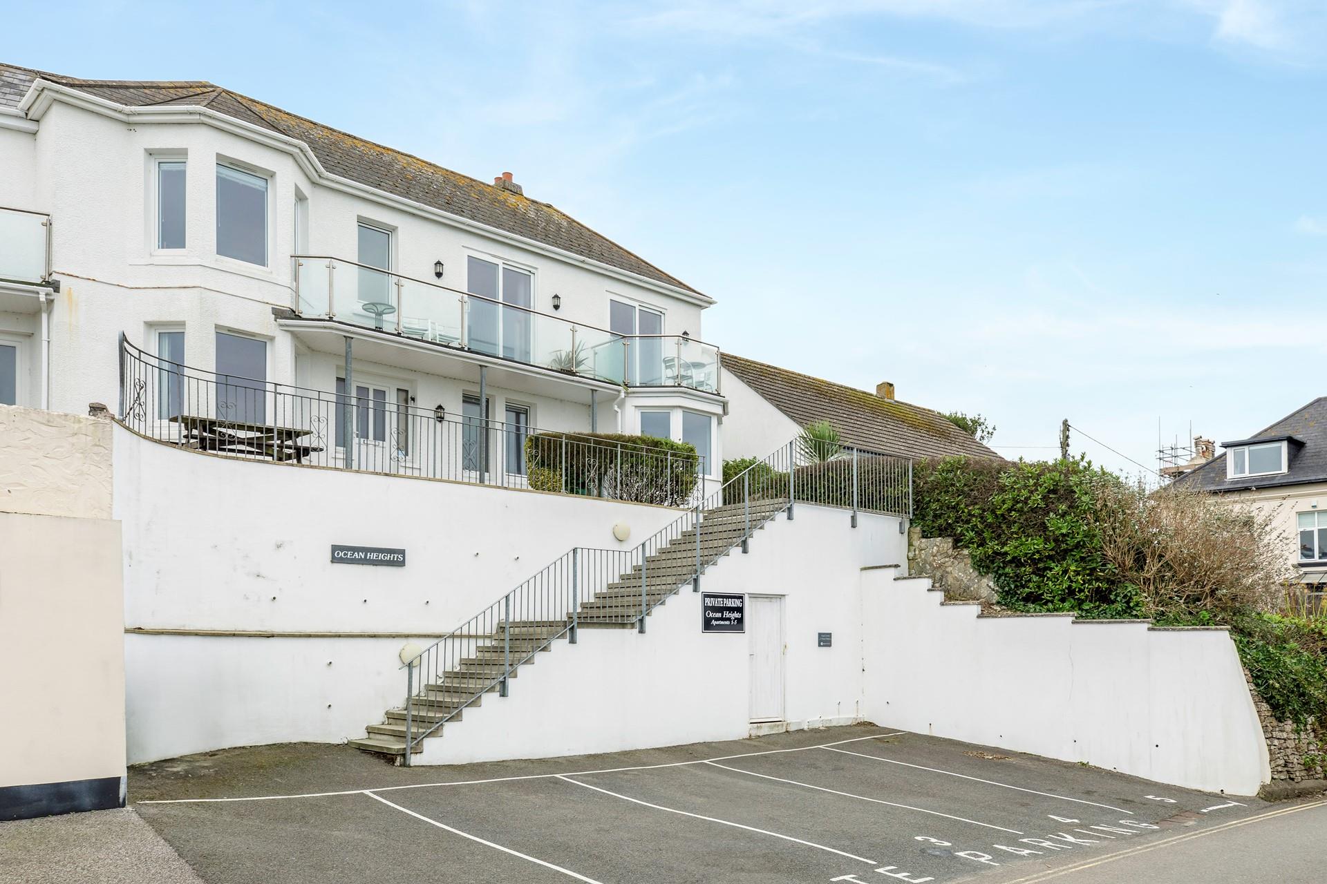 There''s parking for one car and steps up to the apartment.