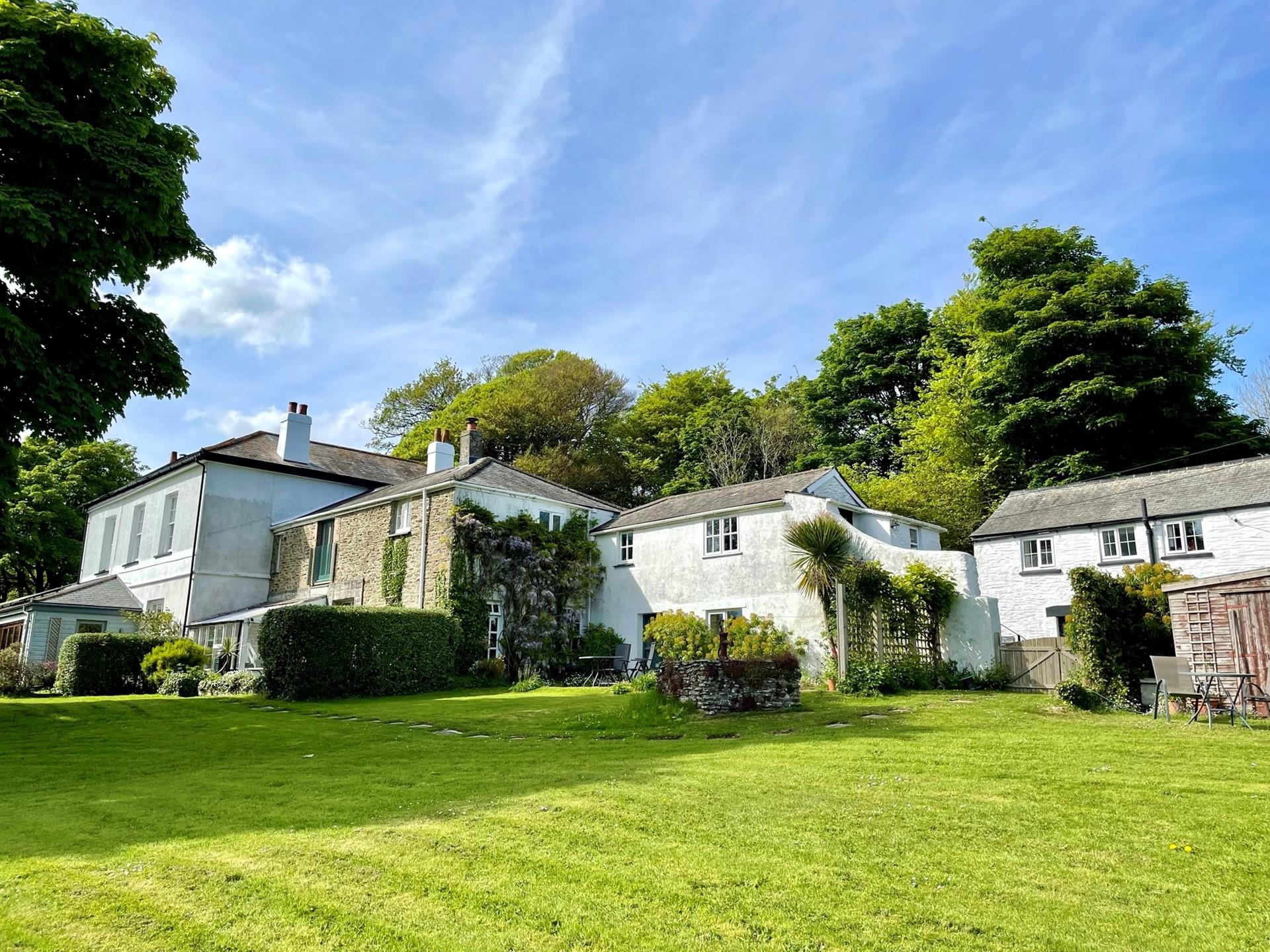 Tucked away in the grounds of a former vicarage with far-reaching coastal views.
