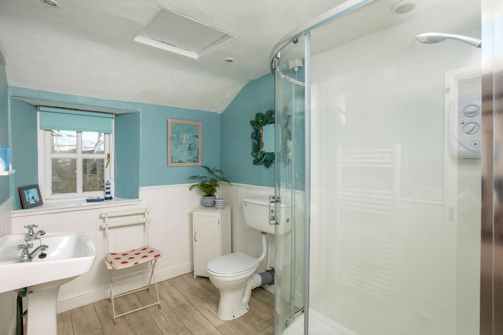 The en suite is light and bright with a spacious shower. 