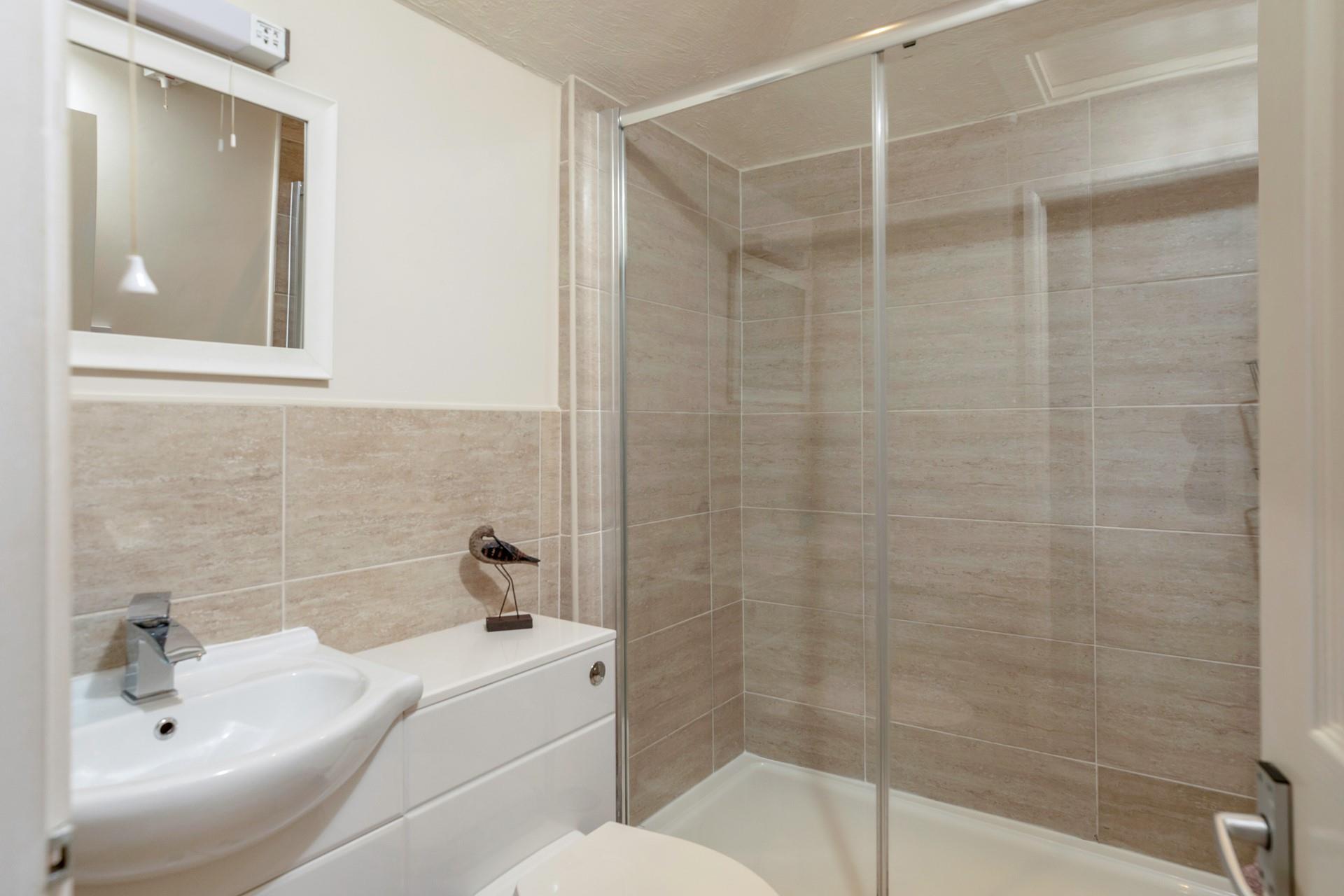 The en suite has an extra large shower and heated towel rail.