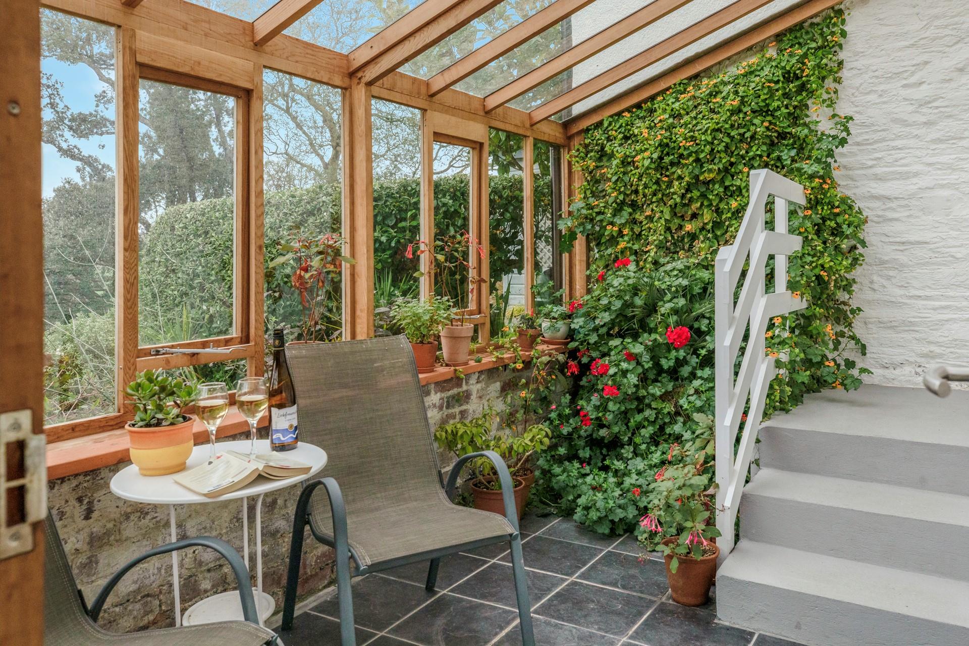 The conservatory is a lovely spot for unwinding with a good book and glass of something chilled.