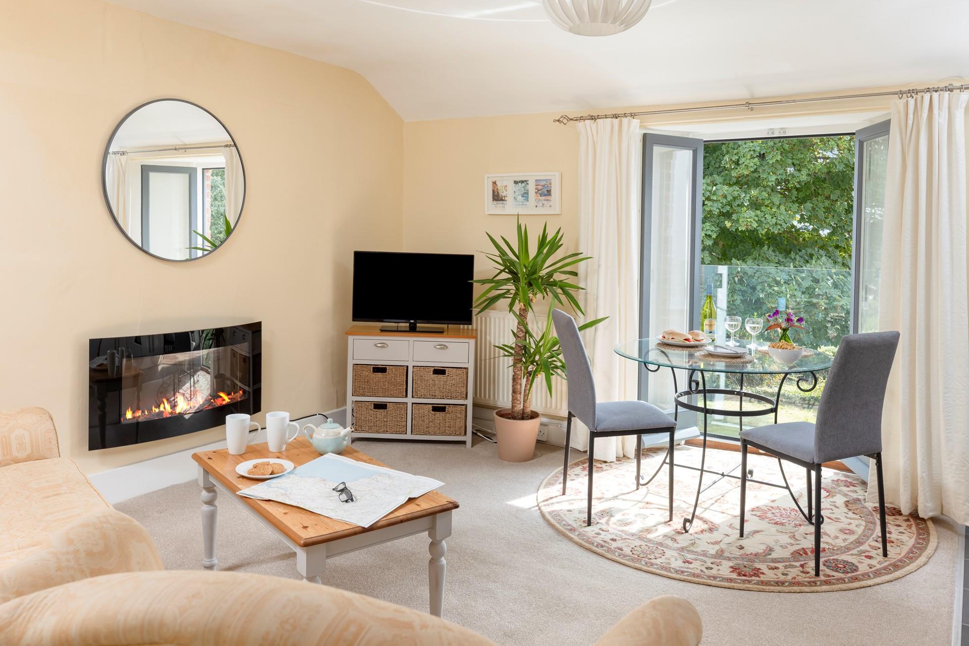 The open plan living area boasts a Juliet balcony showcasing the beautiful view.