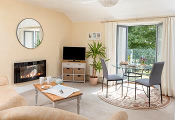 The open plan living area boasts a Juliet balcony showcasing the beautiful view.