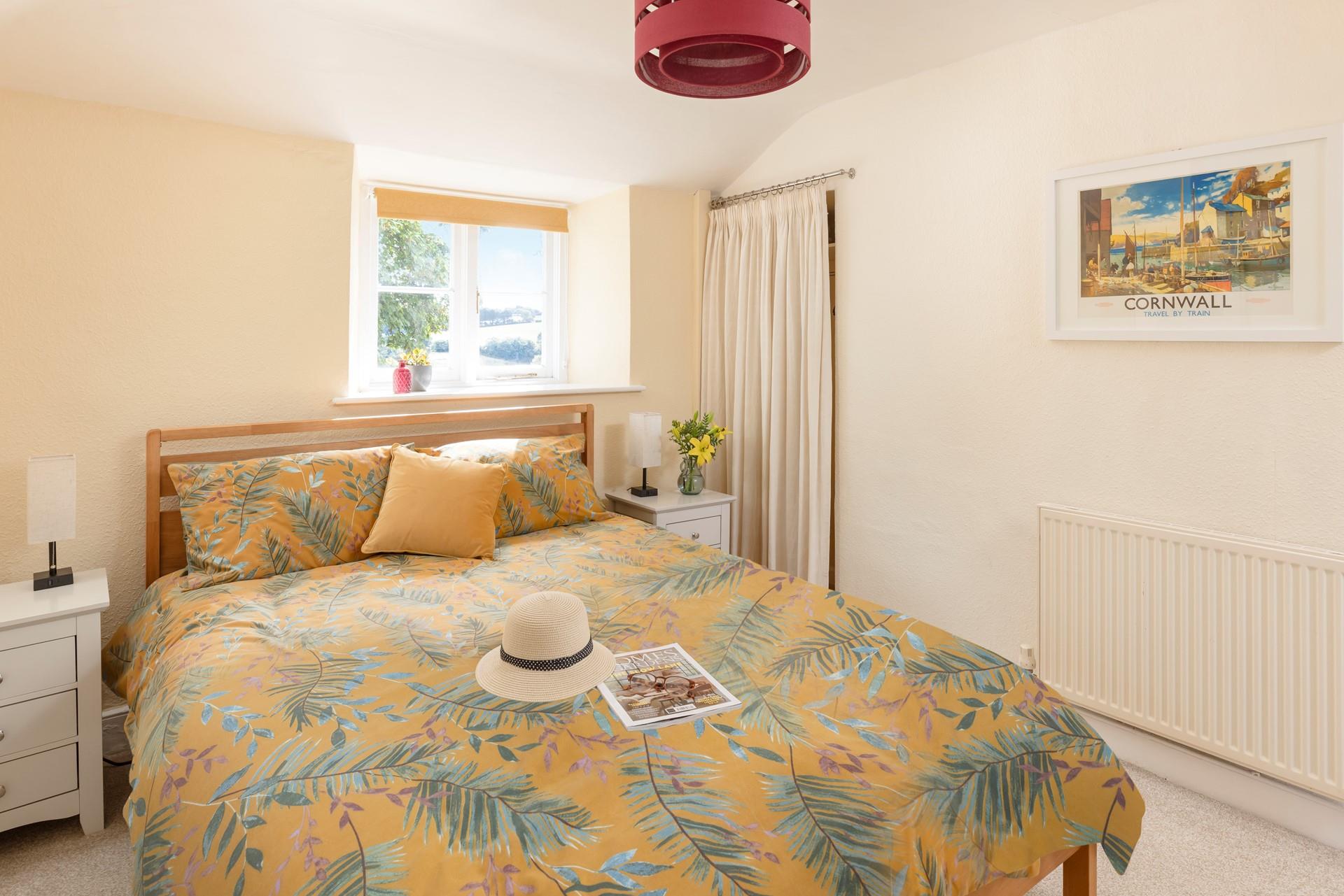 The bedroom has a serene country-style feel.