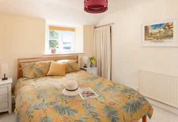 The bedroom has a serene country-style feel.