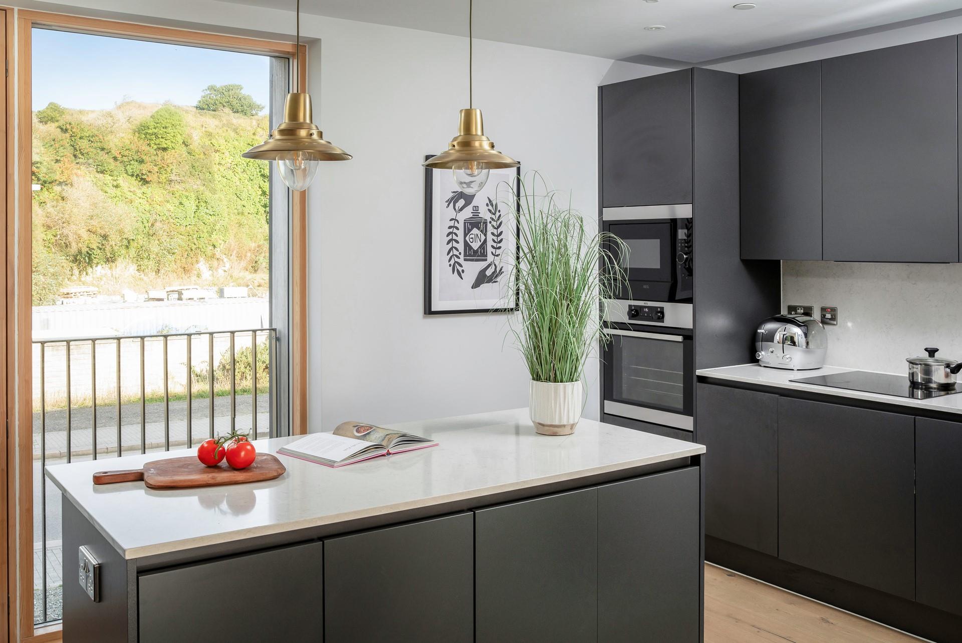 The kitchen is spacious and sleek.