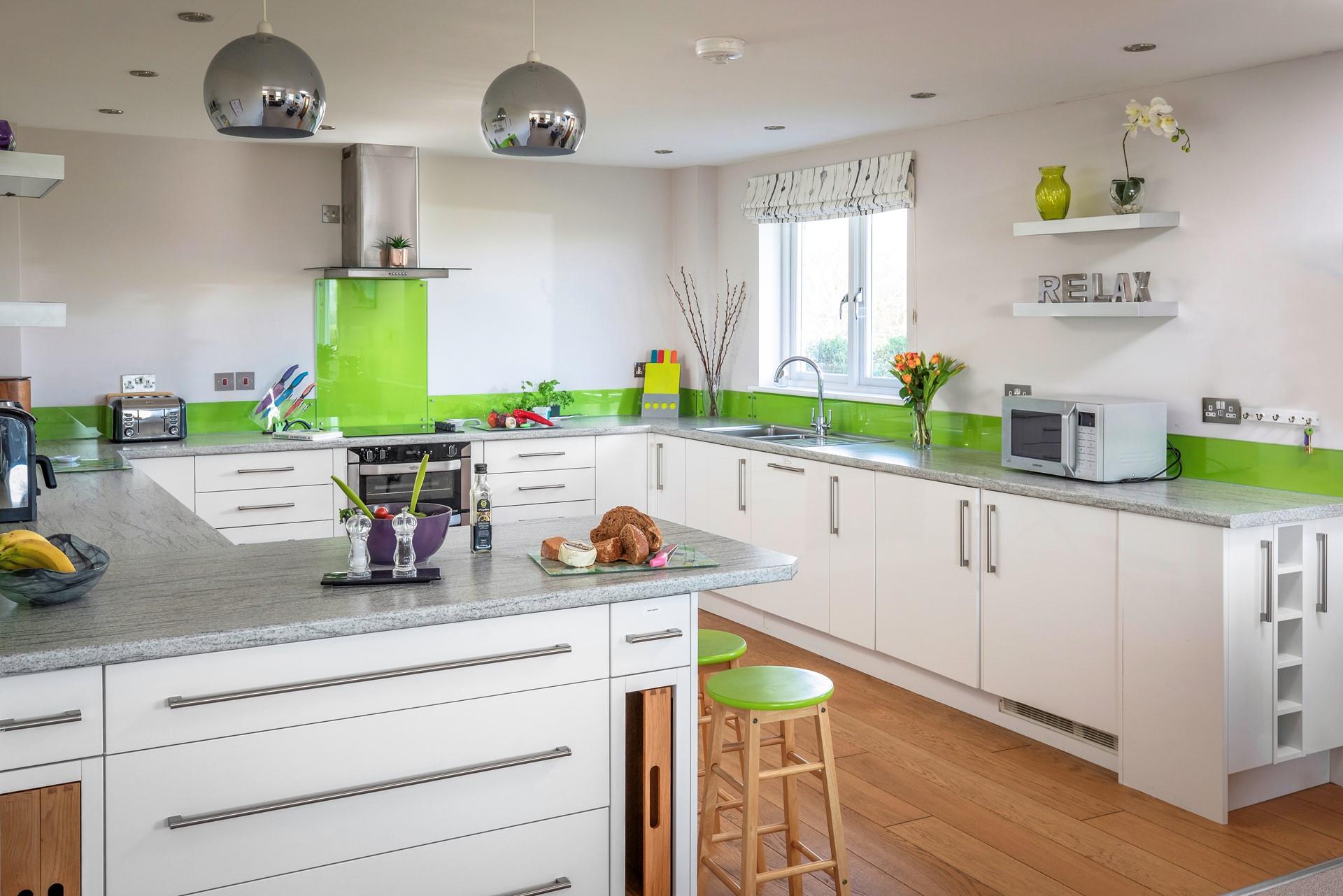 The kitchen is brightly coloured and spacious.