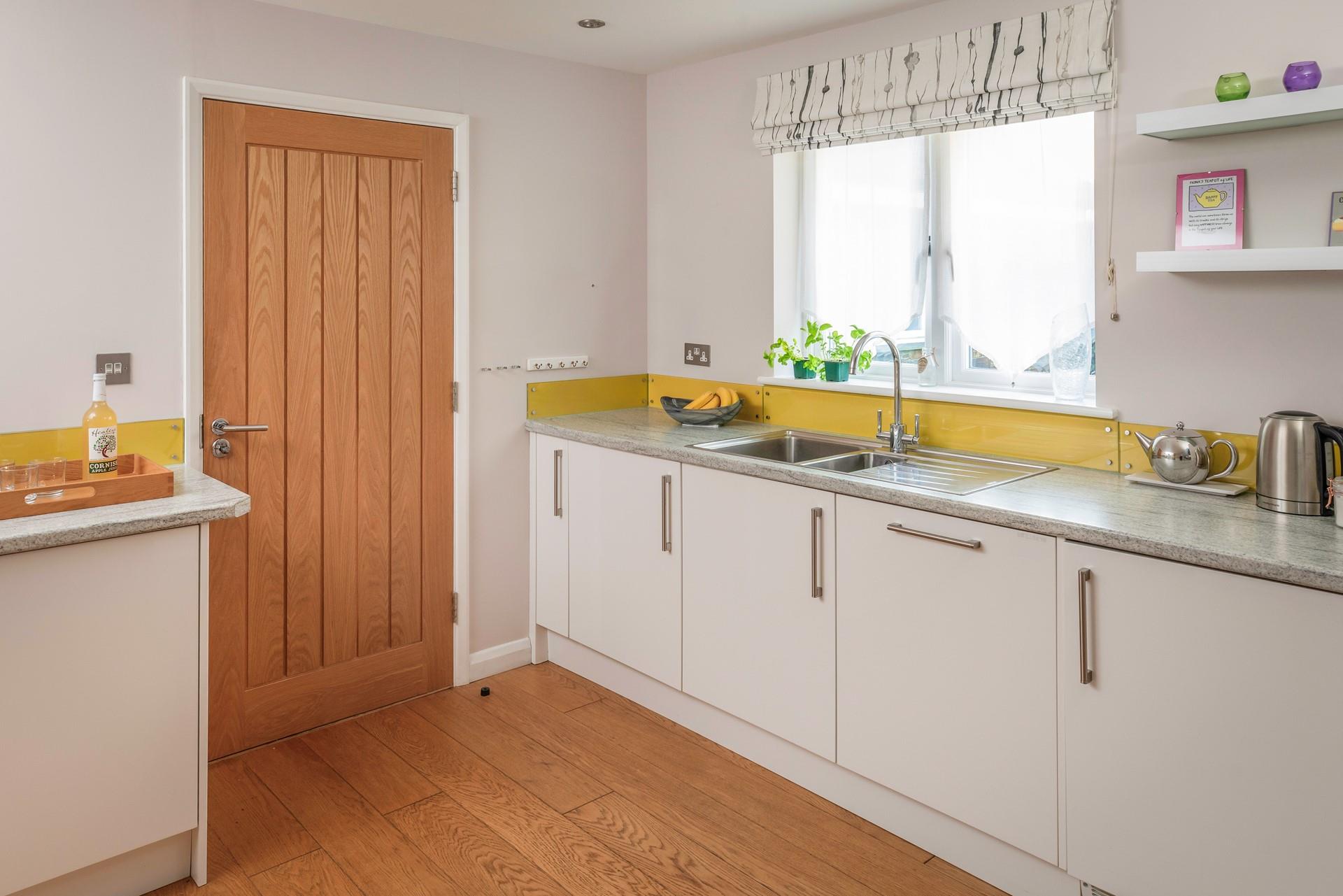 The kitchen is modern and bright.