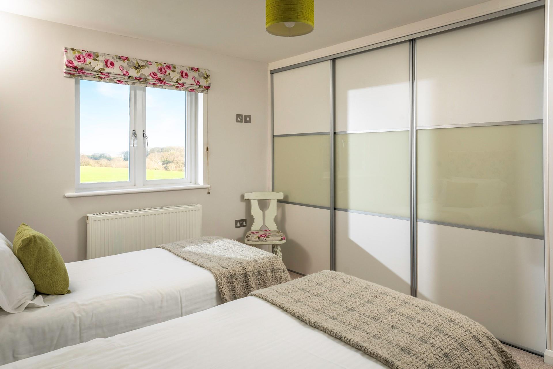 There is a large wardrobe for packing away clothes.