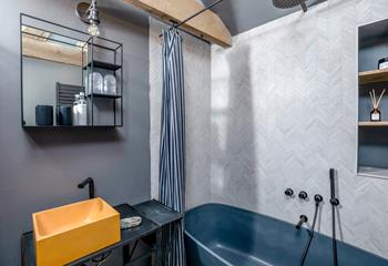 The en suite is beautifully finished with a freestanding bath and a shower.