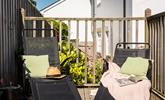 Sunloungers on the raised and terraced decking area are the perfect sunbathing spot. - Thumbnail Image