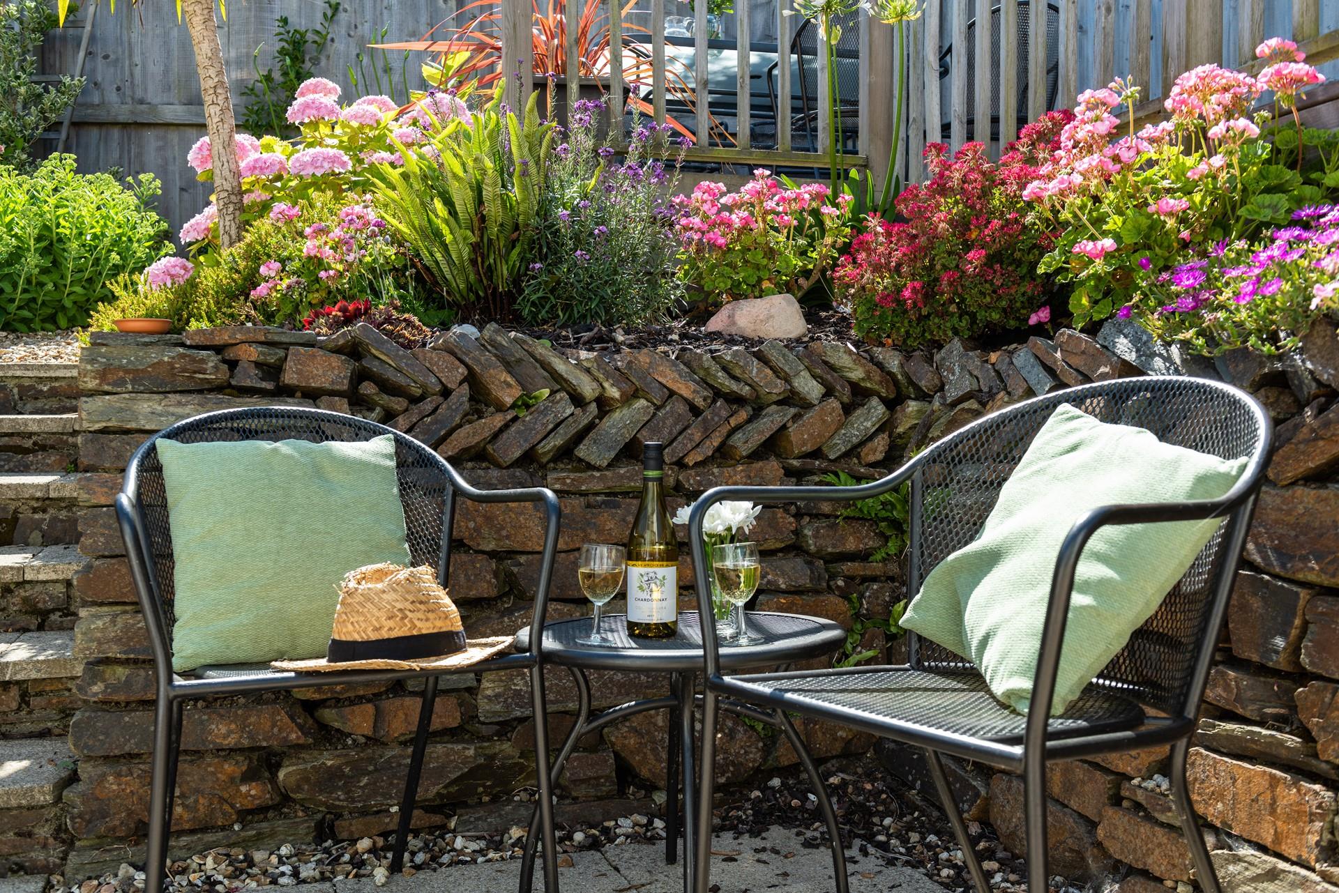 Enjoy a glass of wine surrounded by pretty flowers.