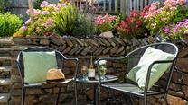 Enjoy a glass of wine surrounded by pretty flowers.