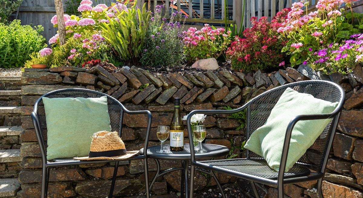 Enjoy a glass of wine surrounded by pretty flowers.