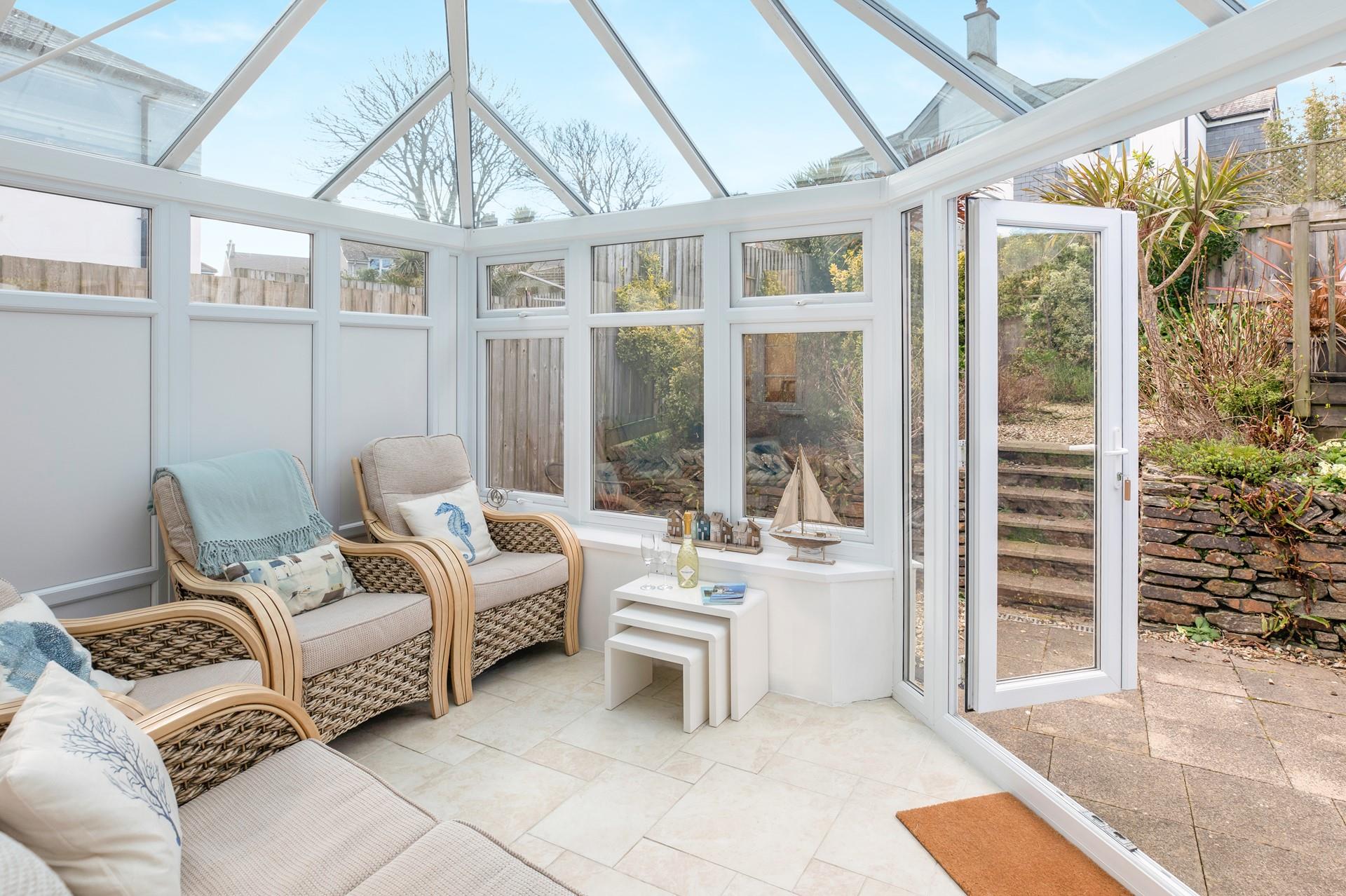 Relax in the conservatory after a day on the beach.