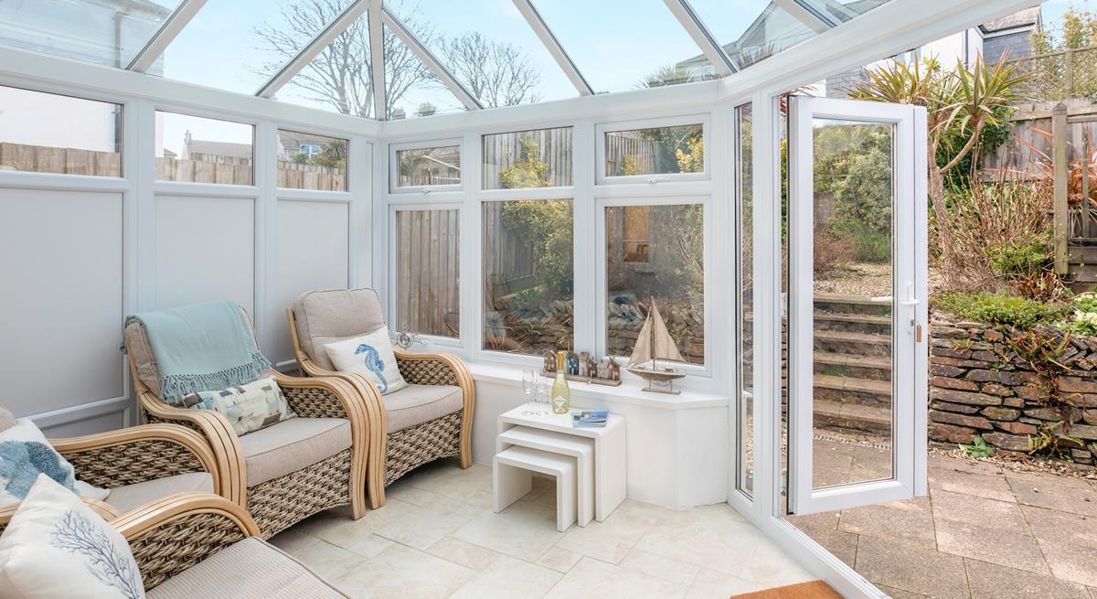 Relax in the conservatory after a day on the beach.