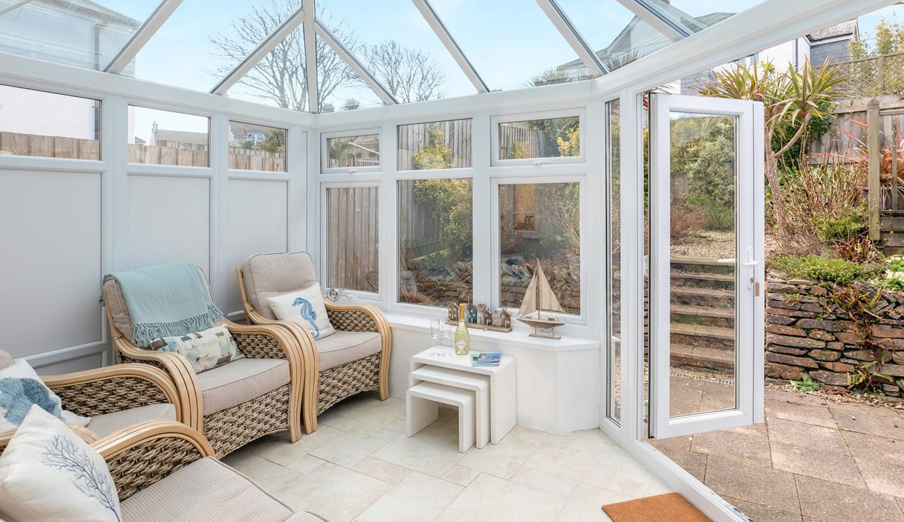 Relax in the conservatory after a day on the beach.