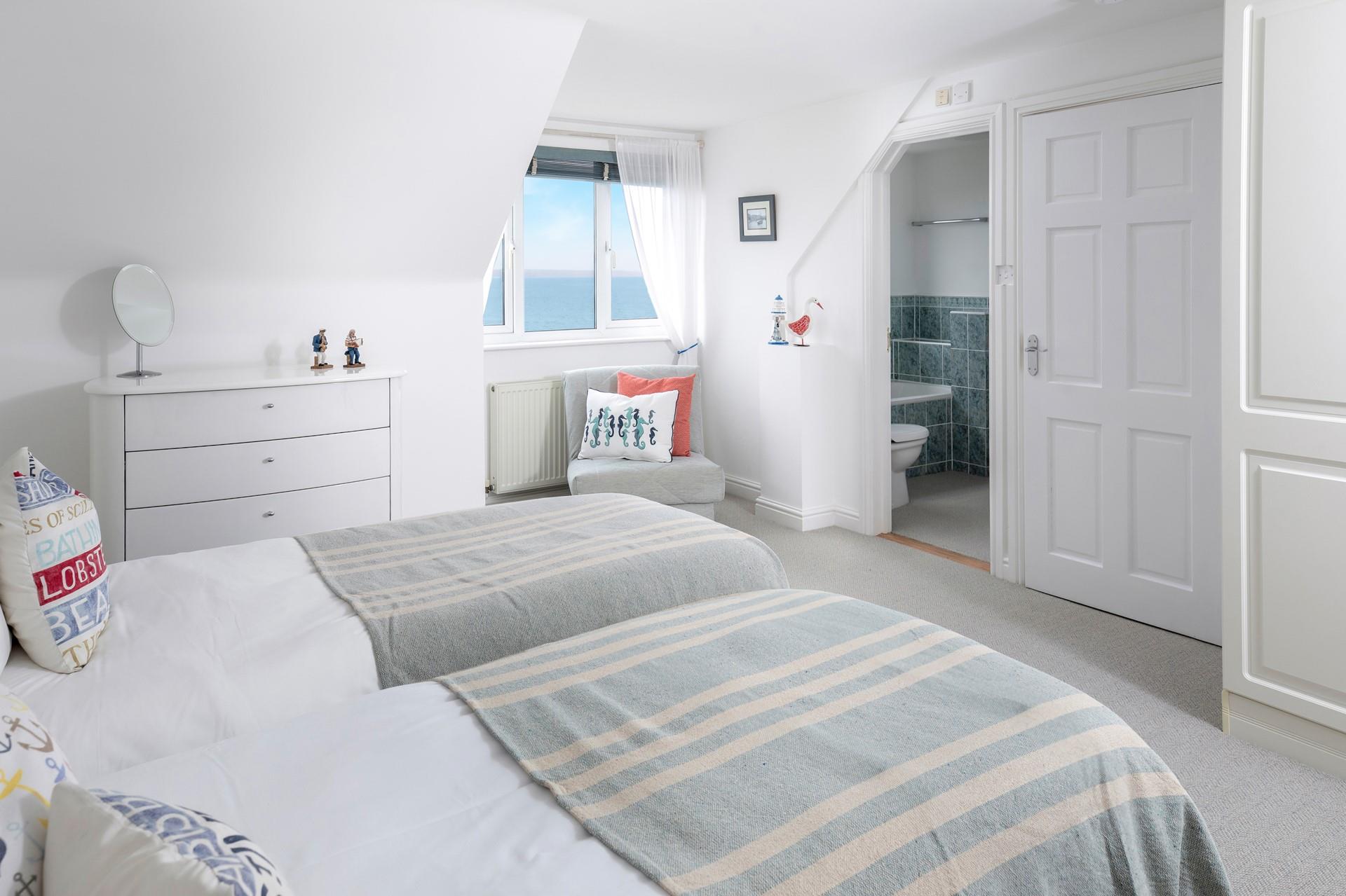 Open the blinds to the sun rising over the sea each morning.