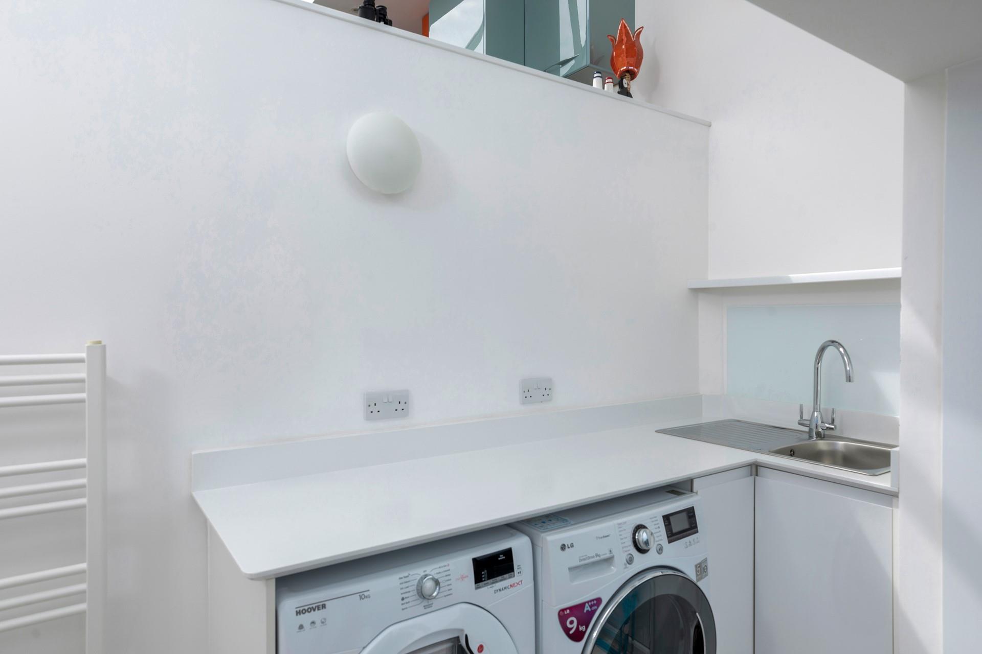 The utility area is equipped with a washer and dryer.