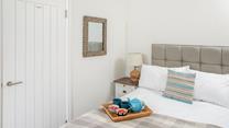 Reflect on the day as you unwind in the comfortable bed.