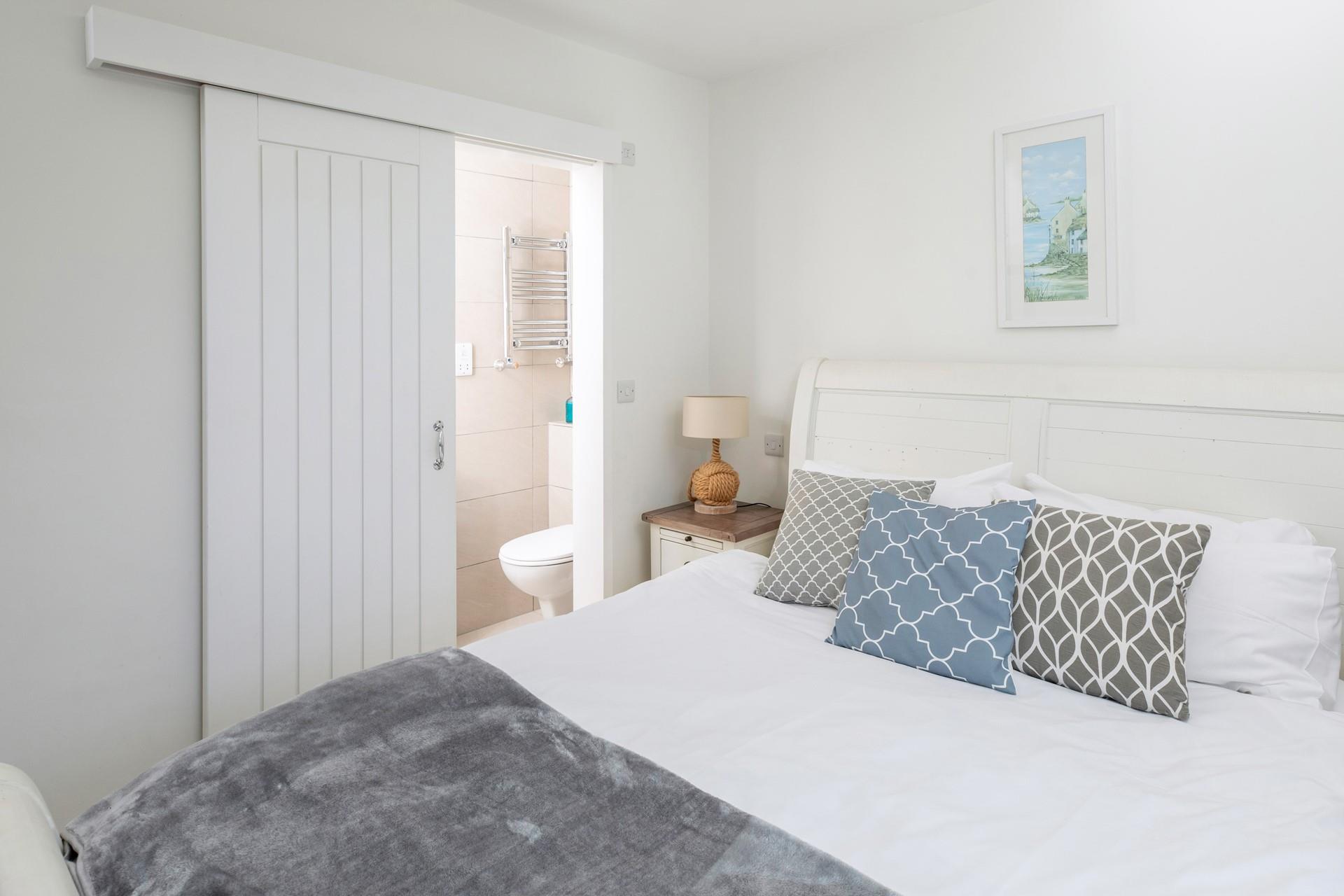 The bedroom is decorated with calming seaside blues.