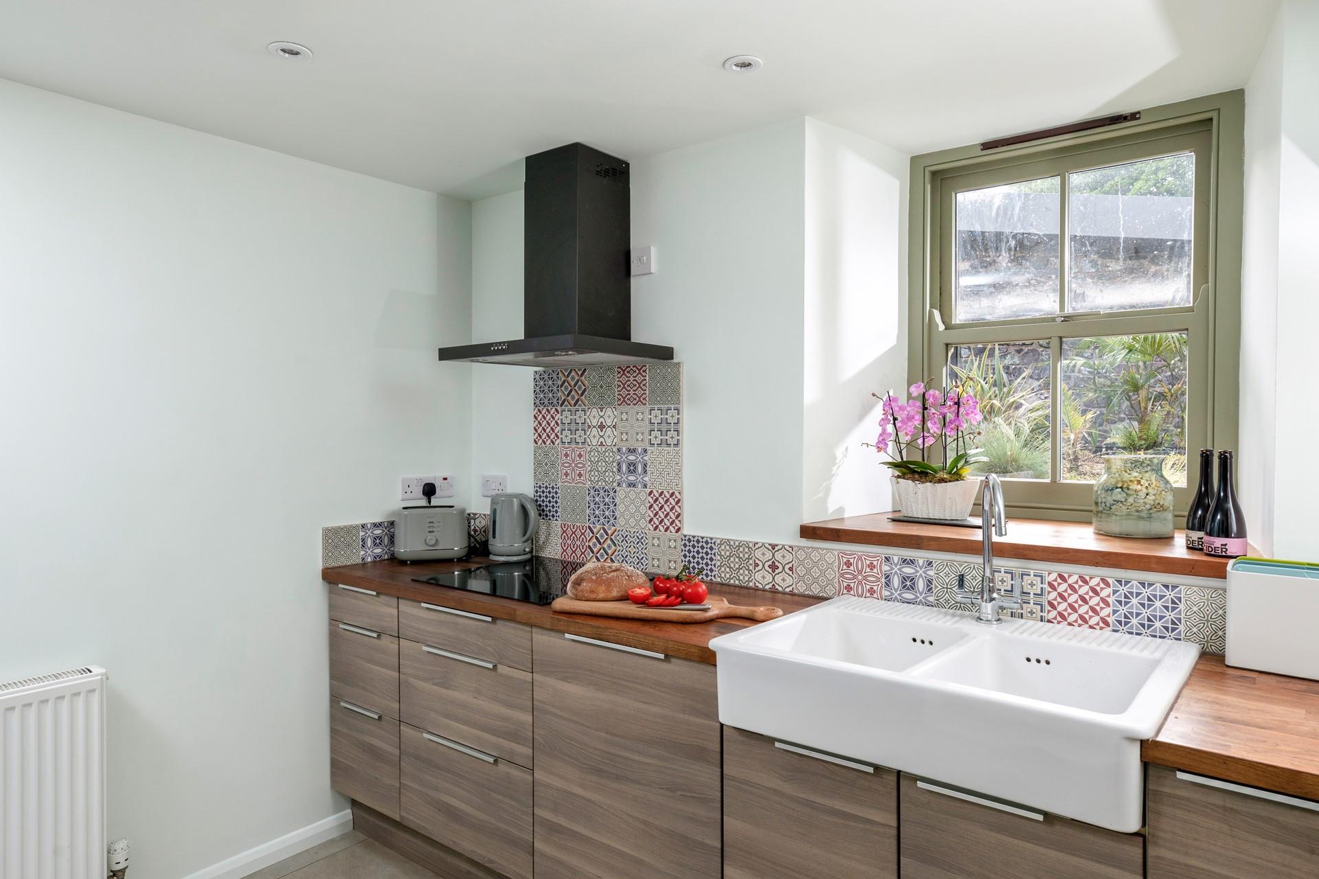 The kitchen looks out into the lush sub-tropical gardens.
